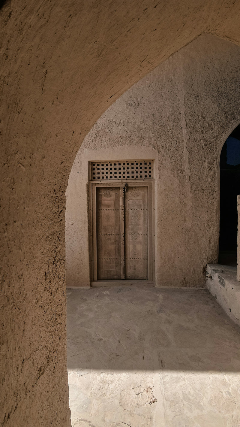 Carved wooden door at Bahla Fort, Oman